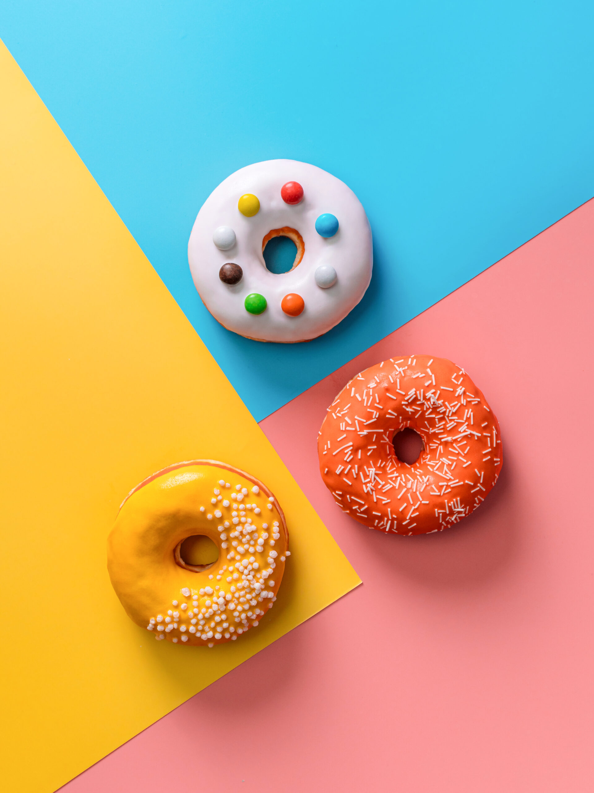 Glazed donuts on colorful background.